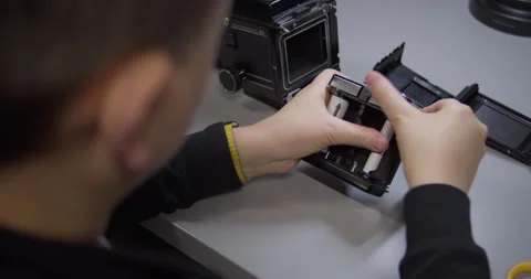 Loading 120 Roll Film into a Medium Format Camera Film Back Stock Footage 315945211