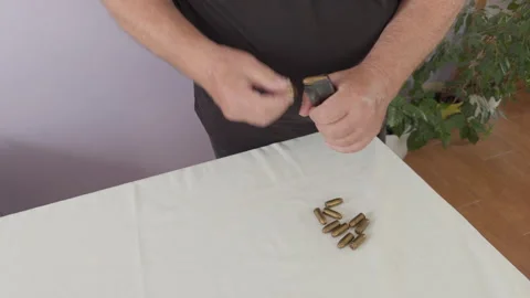 Loading .45 ACP Bullets into Pistol Magazine Stockbeeldmateriaal 337434380