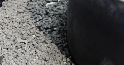 The loading of abrasive material in the grinding installation. Close-Up of Stock Footage 77524276