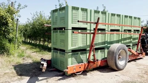 Loading agricultural machine attached to tractor for transporting palox Stock Footage 306622294