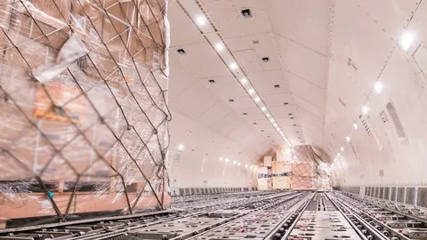 Loading air cargo freighter inside aircraft - Zoom out Stock Footage