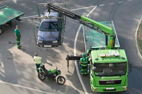 Loading and towing a car for the wrong parking. Stock Photos