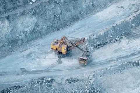 Loading and transportation of stone chips on dump trucks in quar Stock Photos