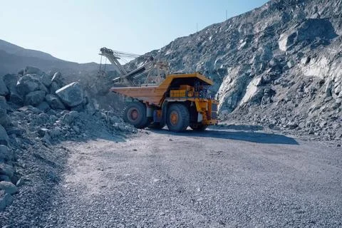 Loading and transportation of stone chips on dump trucks in quar Stock Photos