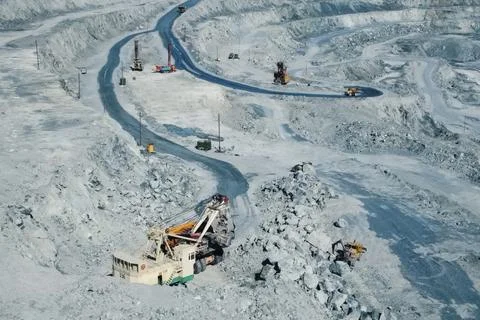 Loading and transportation of stone chips on dump trucks in quarry Stock Photos