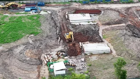 Loading and unloading activities from trucks and excavators leveling the gr.. Stock Footage 333777934