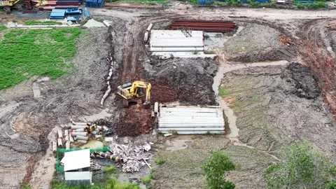 Loading and unloading activities from trucks and excavators leveling the gr.. Video stock 333778080