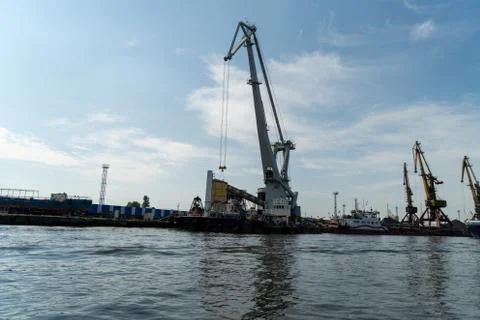 Loading and unloading crane mounted on a small barge Stock Photos