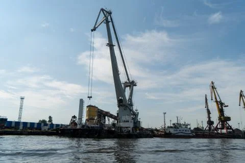 Loading and unloading crane mounted on a small barge Stock Photos