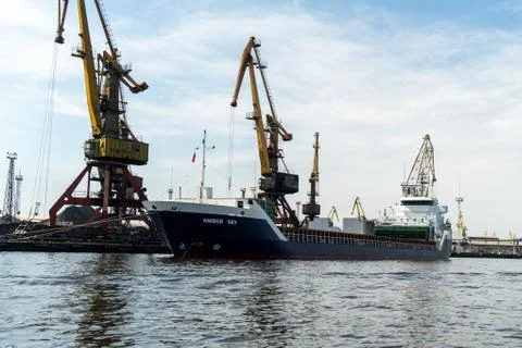 Loading and unloading crane mounted on a small barge Stock Photos