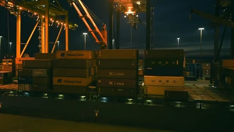 Loading and unloading of goods,  containers on ships at industrial port Stock Footage 104802950