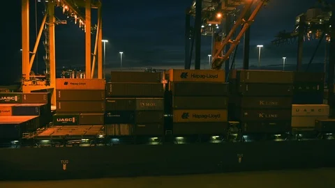 Loading and unloading of goods,  containers on ships at industrial port Stock Footage 104803092