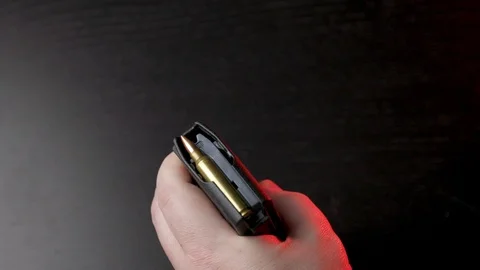 Loading an AR15 magazine, black background Stock Footage 124188759