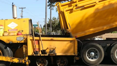 Loading asphalt into paver Stock Footage 143361581