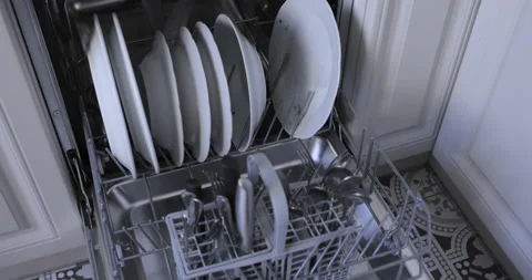 Loading the automatic dishwasher with dirty dishes Stock Footage 138641861