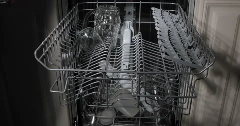 Loading the automatic dishwasher with dirty dishes Stock Footage 140692275
