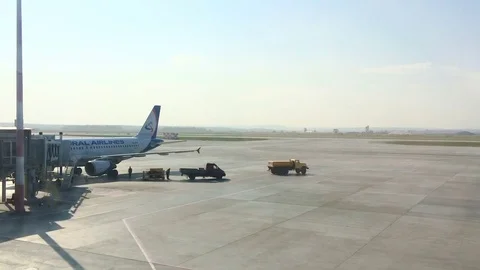 Loading baggage into an airplane on the runway at the airport Stock Footage 74331071