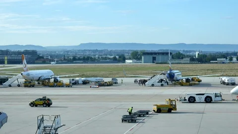 Loading baggage of passengers on a plane at the airport Stock Footage 116158892