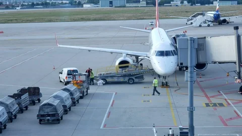 Loading baggage of passengers on a plane at the airport Stock Footage 116272146