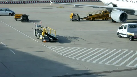 Loading baggage of passengers on a plane at the airport Stock Footage 116416943