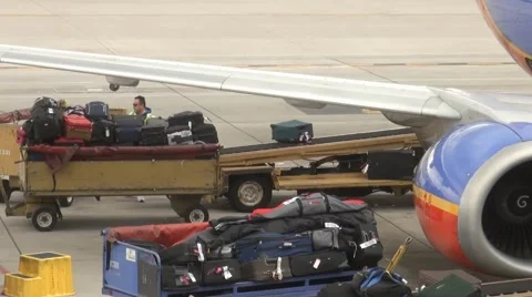 Loading Baggage Onto Plane Stock Footage 1128859