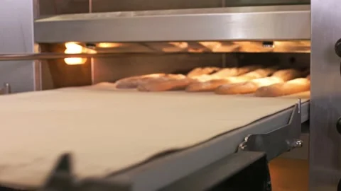 Loading baguettes into a large baking oven Stock Footage 155522980