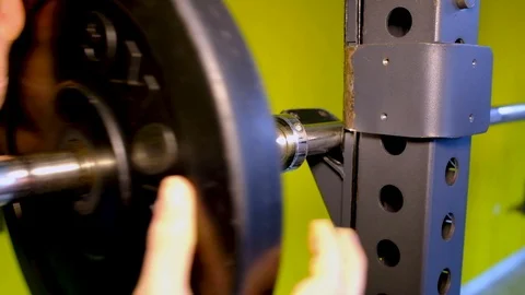 Loading barbell on the rack at the gym Stock Footage 126222768