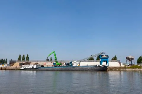 Loading barge with sand and rubble on a small berth Stock Photos