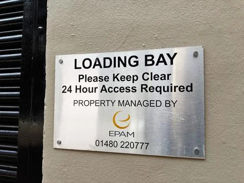 Loading bay sign on building wall instructing 24 hour access and keep clear.. Stock Photos