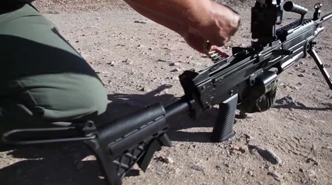 Loading  of belt fed machine gun - M249 SAW Stock Footage 41384613