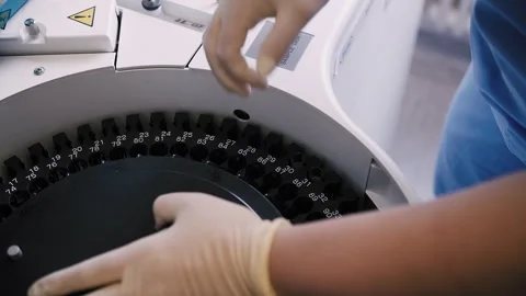 Loading biomaterial into a medical machine for analysis Stock Footage 252955992
