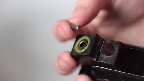 Loading a break barrel air gun rifle with a lead pellet Stock Footage 82729891