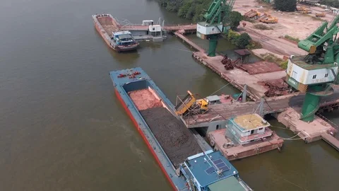 Loading building materials on a barge in a small port. Stock Footage 118032359