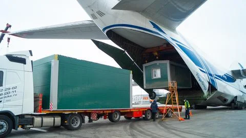 Loading cargo into a cargo plane. Stock Photos