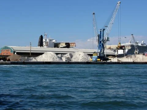Loading cargo of raw materials from a port mooring Stock Photos