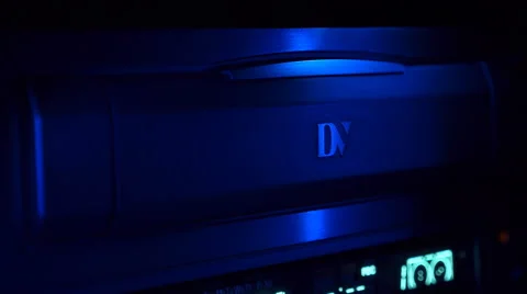 Loading a cassette into video recorder Video stock 49699446