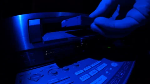 Loading a cassette into video recorder Stock Footage 49700076