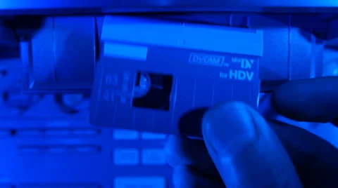 Loading a cassette into video recorder Stock Footage 49701135