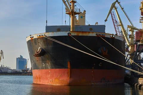 Loading cast iron ingots on ship bulk. Loading metal on ship. Industrial port Stock Photos