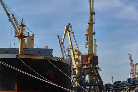 Loading cast iron ingots on ship bulk. Loading metal on ship. Industrial port Stock Photos