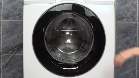 Loading clothes into the washing machine Stock Footage 125913632
