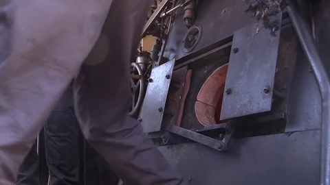 Loading the coal into a boiler of steam train, 1915 italian steam locomitive 685 Stock Footage 93587766