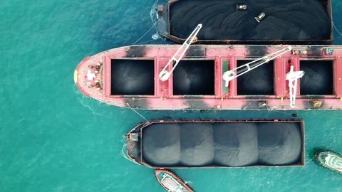 Loading coal on bulk vessel ship in offshore cargo port. Aerial top view. Stock Footage