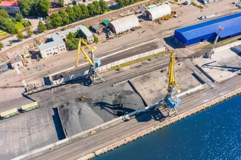 Loading coal mining in port on cargo tanker ship with crane bucket of train.  Stock Photos