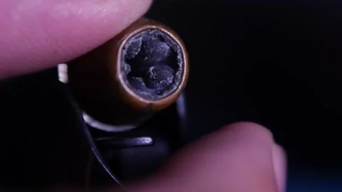 Loading Colt 1911 gun magazine with hollow point bullets, macro oblique shot Stock Footage 154568400