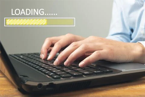 Loading concept with woman using a laptop in a home office. Freelance, online Stock Photos