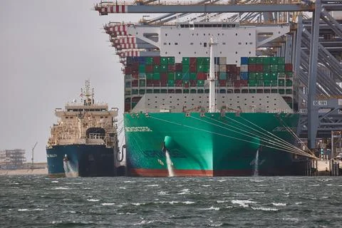 Loading containers on a huge cargo ship Stock Photos