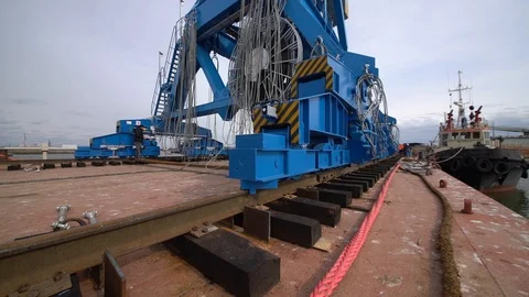 Loading a crane on a barge in a port, close-up Stock Footage 122696664