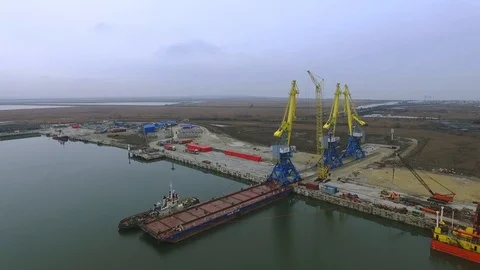 Loading cranes on a barge, Temryuk Commercial Sea Port, Russia, aerial view Stock Footage 122696803