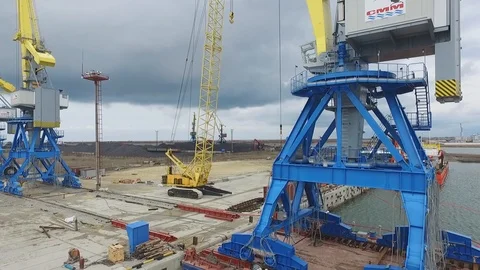 Loading cranes on a barge, Temryuk Commercial Sea Port, Russia, aerial view Stock Footage 122697125